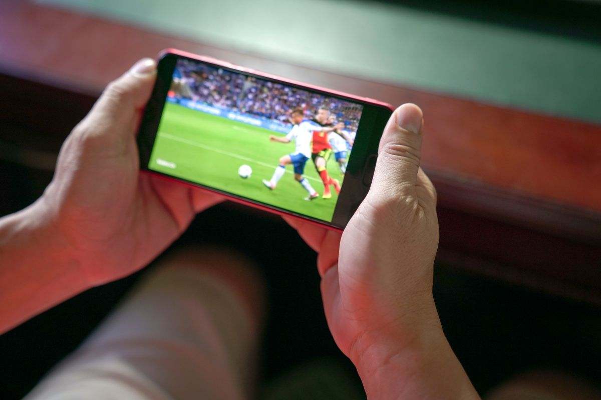 Persona che segue la partita live sullo smartphone
